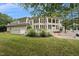 Inviting back exterior features an expansive window display, multiple decks, and a well-maintained backyard at 5317 Moonflower Ct, Holly Springs, NC 27540