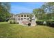 Inviting back exterior with an expansive window display, multiple decks, and a well-maintained backyard at 5317 Moonflower Ct, Holly Springs, NC 27540