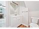 Well-lit bathroom with a modern vanity, mirror, and fixtures, complemented by stylish flooring and a toilet at 5317 Moonflower Ct, Holly Springs, NC 27540