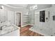 Bright bathroom featuring a glass enclosed shower with decorative tile and a granite countertop sink at 5317 Moonflower Ct, Holly Springs, NC 27540
