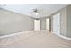 Spacious bedroom with neutral paint, plush carpet, and a ceiling fan at 5317 Moonflower Ct, Holly Springs, NC 27540