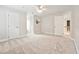 Large bedroom with a ceiling fan and neutral carpet and paint at 5317 Moonflower Ct, Holly Springs, NC 27540