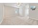 Bedroom with neutral carpet, a window, and a television mounted on the wall at 5317 Moonflower Ct, Holly Springs, NC 27540