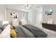 Neutral bedroom with ceiling fan, television and sitting area at 5317 Moonflower Ct, Holly Springs, NC 27540