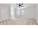 Bright bedroom with neutral walls, carpet flooring, and two doors, creating a serene and inviting space at 5317 Moonflower Ct, Holly Springs, NC 27540