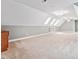 Large, carpeted bonus room with built-in shelves and three skylights at 5317 Moonflower Ct, Holly Springs, NC 27540