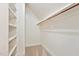 Walk-in closet with custom shelving and hanging rod for optimal storage at 5317 Moonflower Ct, Holly Springs, NC 27540