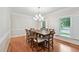 Bright dining room with large wooden table and shuttered windows at 5317 Moonflower Ct, Holly Springs, NC 27540