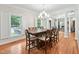 Dining room features a wooden table with seating for eight, complemented by abundant natural light at 5317 Moonflower Ct, Holly Springs, NC 27540