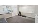 Home gym showcasing weights and rubber flooring, part of a multi-functional bonus space in the residence at 5317 Moonflower Ct, Holly Springs, NC 27540