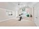 Bright exercise room includes an elliptical, mirror, and natural light, perfect for a home gym setup at 5317 Moonflower Ct, Holly Springs, NC 27540