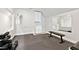 Dedicated home gym area with weights, mirrors, and a sink, perfect for maintaining a healthy lifestyle at 5317 Moonflower Ct, Holly Springs, NC 27540