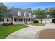 Charming home featuring a welcoming front porch, well-manicured lawn, and a spacious driveway leading to an attached garage at 5317 Moonflower Ct, Holly Springs, NC 27540