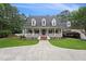 Lovely home with a wide front porch, tidy landscaping, and a concrete driveway leading to an attached garage at 5317 Moonflower Ct, Holly Springs, NC 27540