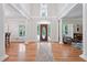 Grand foyer with soaring ceilings, hardwood floors, and an elegant front door at 5317 Moonflower Ct, Holly Springs, NC 27540