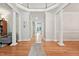 Stately foyer with hardwood floors, columns, and a view of the staircase and multiple hallways at 5317 Moonflower Ct, Holly Springs, NC 27540