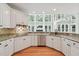 Kitchen featuring granite countertops, stainless appliances and large windows providing tons of light at 5317 Moonflower Ct, Holly Springs, NC 27540