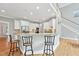 Kitchen featuring granite counters, modern stainless steel appliances and a breakfast bar at 5317 Moonflower Ct, Holly Springs, NC 27540