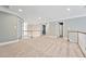 Upstairs living room with carpet, light-colored walls, and wooden railings showcases the home's cozy ambiance at 5317 Moonflower Ct, Holly Springs, NC 27540