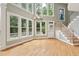 Bright living room with many windows and hardwood floors at 5317 Moonflower Ct, Holly Springs, NC 27540