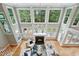 Aerial view of a living room, with large windows and a fireplace, showcasing the bright and airy space at 5317 Moonflower Ct, Holly Springs, NC 27540