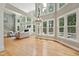 Spacious living room features tall windows, a fireplace, and wood floors at 5317 Moonflower Ct, Holly Springs, NC 27540
