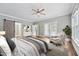 Relaxing main bedroom with a ceiling fan, sliding barn door closet, and access to the backyard at 5317 Moonflower Ct, Holly Springs, NC 27540