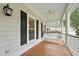 Cozy porch featuring a hanging swing, ceiling fan, and view of the yard at 5317 Moonflower Ct, Holly Springs, NC 27540