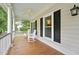 Relaxing porch area with rocking chairs, ceiling fan, and view of the outdoor scenery at 5317 Moonflower Ct, Holly Springs, NC 27540