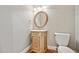 Powder room with a decorative vanity and an oval mirror at 5317 Moonflower Ct, Holly Springs, NC 27540