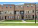 Three-story brick townhouse with individual balconies, a front entrance, and manicured lawn at 547 Forestville Rd, Wake Forest, NC 27587