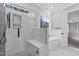 Modern bathroom with glass shower, river rock floor, luxurious bathtub, and natural light at 5504 Earle Road, Raleigh, NC 27606