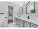 Modern bathroom featuring double vanity, quartz counters, and updated fixtures at 5504 Earle Road, Raleigh, NC 27606