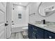 Bathroom boasts custom blue vanity and a tiled shower/tub combo at 5504 Earle Road, Raleigh, NC 27606