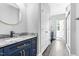 Modern bathroom vanity featuring marble countertop, gold hardware, and round mirror at 5504 Earle Road, Raleigh, NC 27606