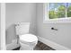 Bathroom features a toilet and a large window with natural lighting at 5504 Earle Road, Raleigh, NC 27606