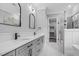 Modern bathroom with double vanity, walk-in shower, quartz countertops, and black fixtures at 5504 Earle Road, Raleigh, NC 27606