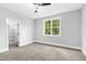 Bedroom showcasing a large window, a ceiling fan, and a closet at 5504 Earle Road, Raleigh, NC 27606