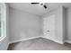 Carpeted bedroom featuring a ceiling fan, closet, and natural light, perfect for relaxation at 5504 Earle Road, Raleigh, NC 27606