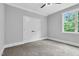 Bedroom features carpet floors, natural lighting, and a double-door closet for storage at 5504 Earle Road, Raleigh, NC 27606