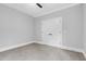 Bedroom boasts neutral tones, carpet floors, a ceiling fan, and a double-door closet at 5504 Earle Road, Raleigh, NC 27606