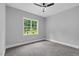 Neutral bedroom with carpet, ceiling fan, and a bright window at 5504 Earle Road, Raleigh, NC 27606