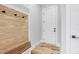 Inviting entryway features custom wood bench and coat rack and transitions to light and bright living areas at 5504 Earle Road, Raleigh, NC 27606