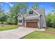 Two-story home with gray siding, stone accents, and a visible two car garage at 5504 Earle Road, Raleigh, NC 27606