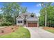 Charming two-story home with gray siding, stone accents, and a well-manicured front yard at 5504 Earle Road, Raleigh, NC 27606
