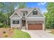 Charming two-story home with gray siding, stone accents, and a covered garage at 5504 Earle Road, Raleigh, NC 27606