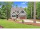 Charming two-story home with gray siding, stone accents, and a covered garage at 5504 Earle Road, Raleigh, NC 27606