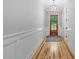 Bright foyer with wood floors, wainscoting, and stylish lighting, leading into the home at 5504 Earle Road, Raleigh, NC 27606