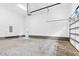 Bright garage with concrete floors and white walls, featuring a modern garage door at 5504 Earle Road, Raleigh, NC 27606