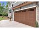 Spacious two-car garage with carriage doors and a concrete driveway for easy access and parking at 5504 Earle Road, Raleigh, NC 27606